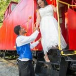 Couple in front of old train at Apple Ridge Farm wedding venue